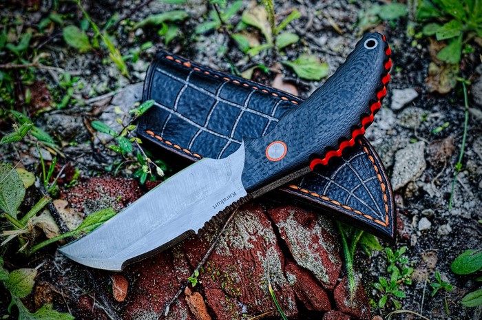Karakurt knife with leather sheath on forest floor