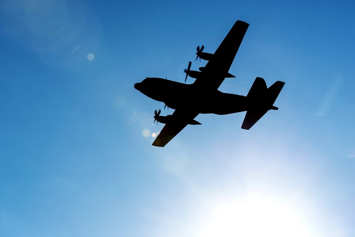 Silhouette of a C-130 Hercules airplane in the sky