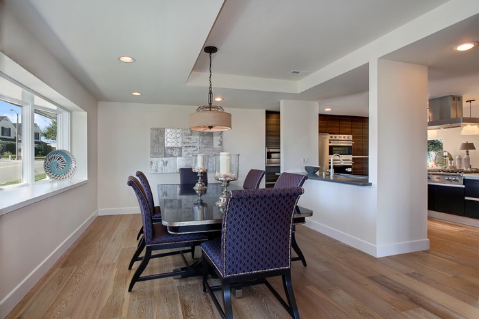 Dining Room with Chandelier and Kitchen View
