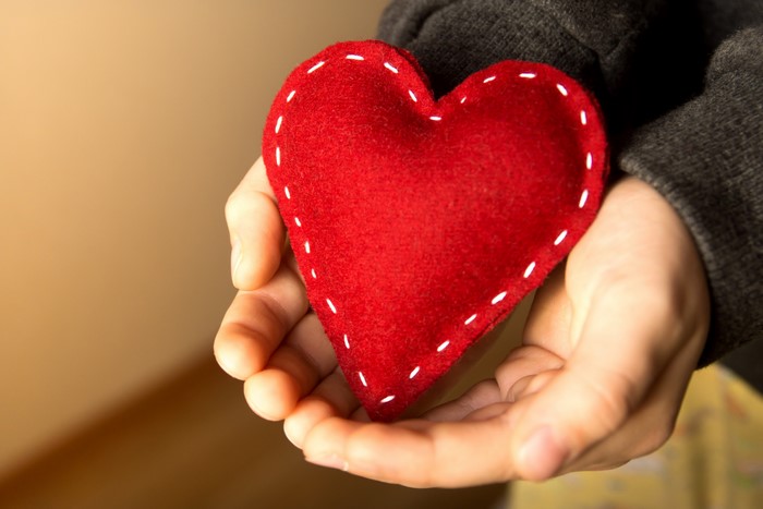 Hands holding a red heart