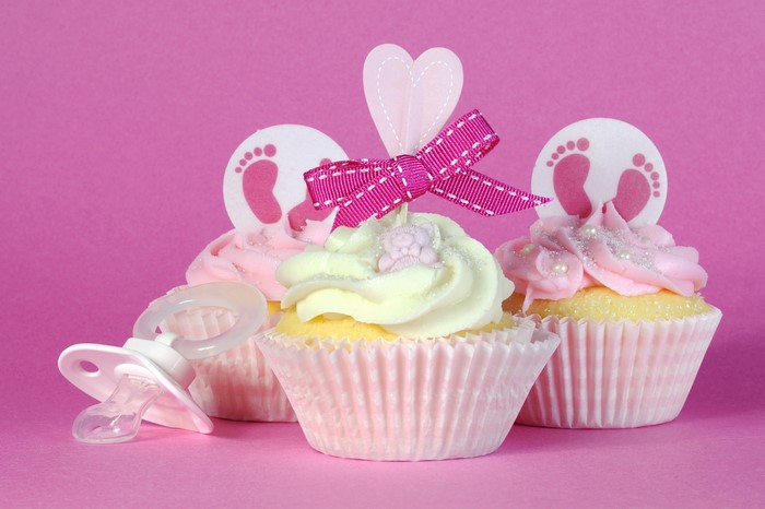 Cupcakes with baby feet decorations and a pacifier