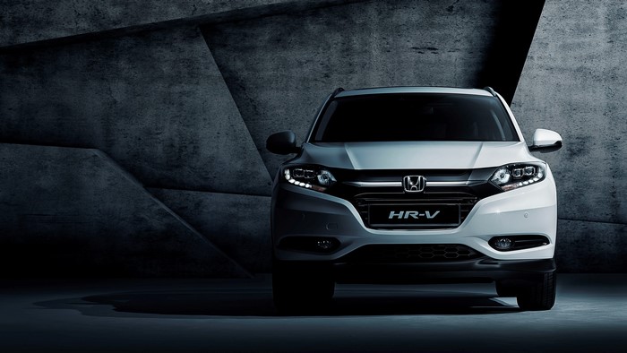 White Honda HR-V parked in front of a concrete wall