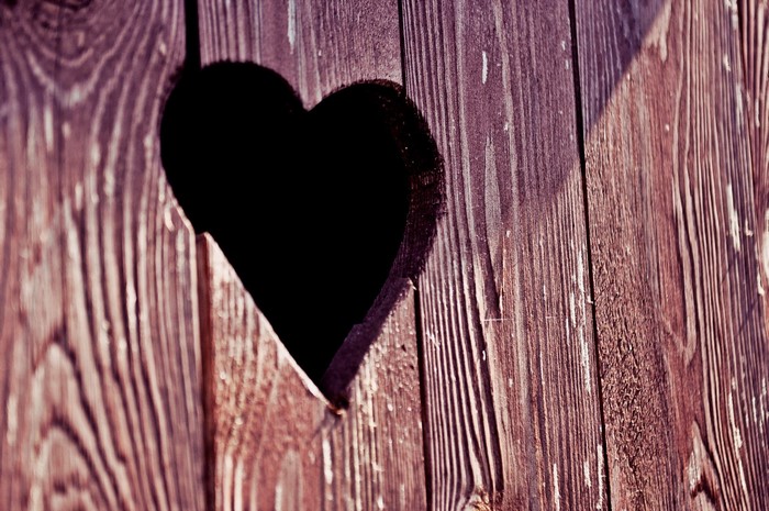 Heart-shaped hole in wooden planks