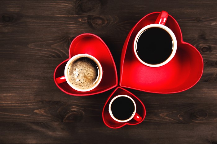 Three cups of coffee in heart-shaped saucers