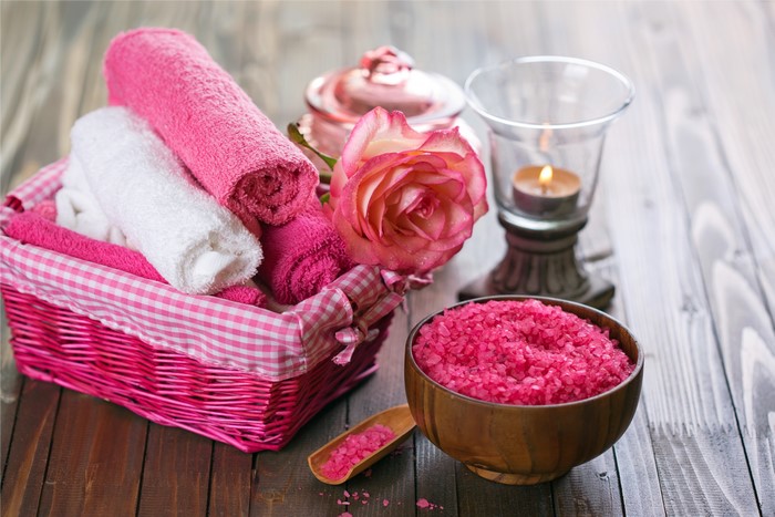 Spa basket with towels, rose, candle, and salt