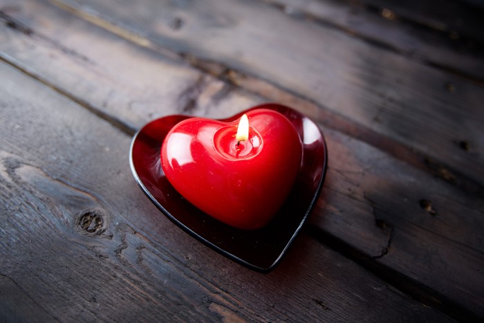 Red Heart Candle on Wooden Planks