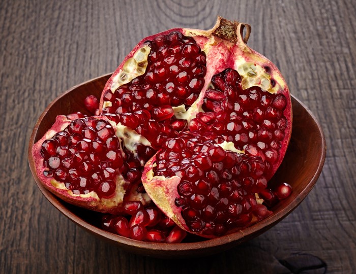 Pomegranate in a wooden bowl