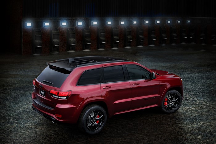 Red Jeep Grand Cherokee SRT parked in front of arcade machines