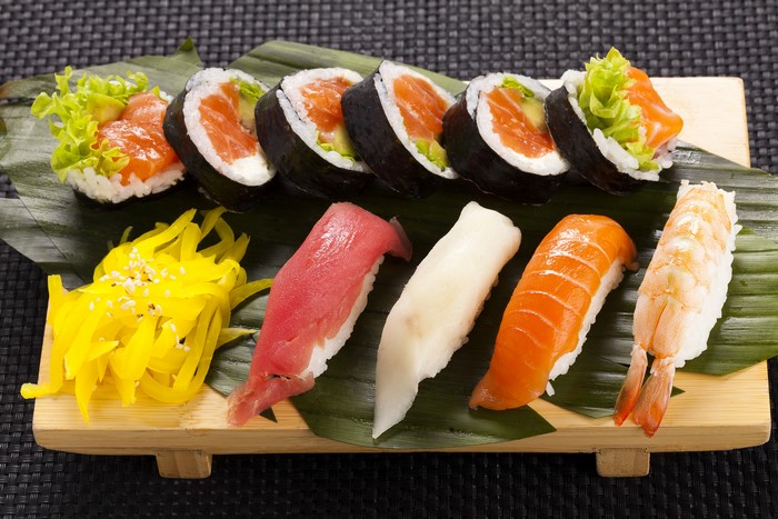 Sushi platter with salmon, tuna, shrimp, and pickled ginger
