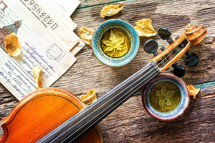 Violin and letters on a wooden table