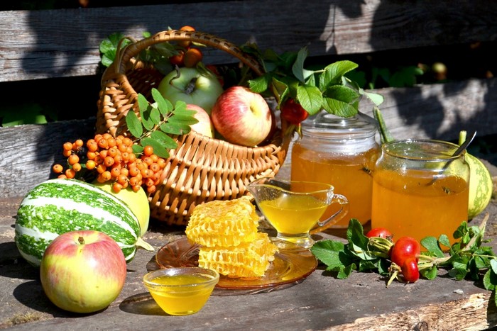 Autumn harvest of apples, honey, and gourds