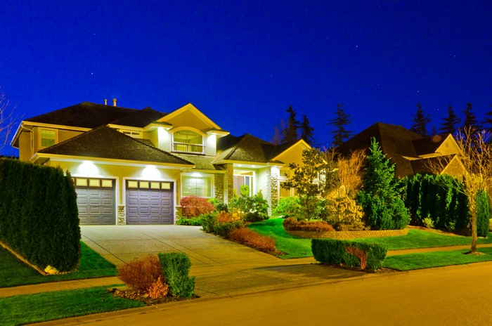 Luxury Houses with Garages and Landscaping at Night