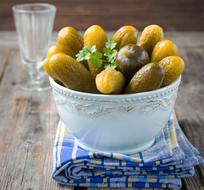 Bowl of pickles with a shot glass