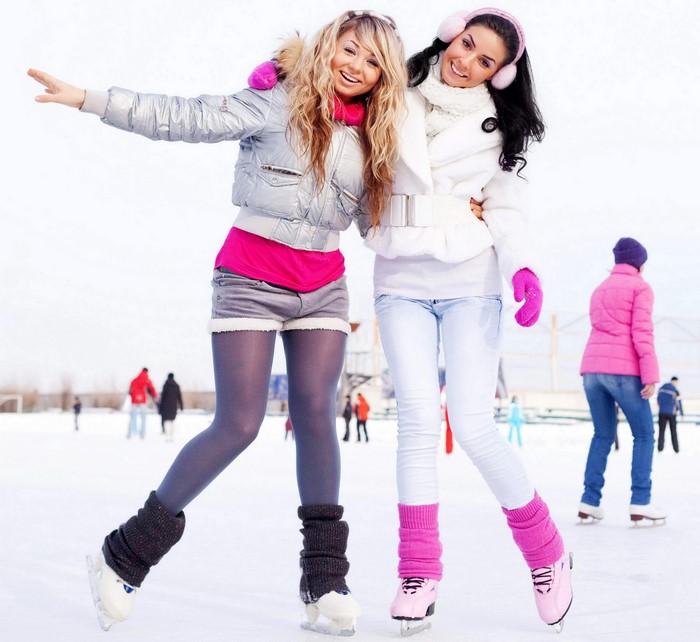 Two Friends Ice Skating Together in Winter
