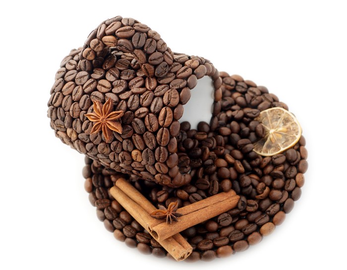 Coffee cup and saucer made of coffee beans with spices