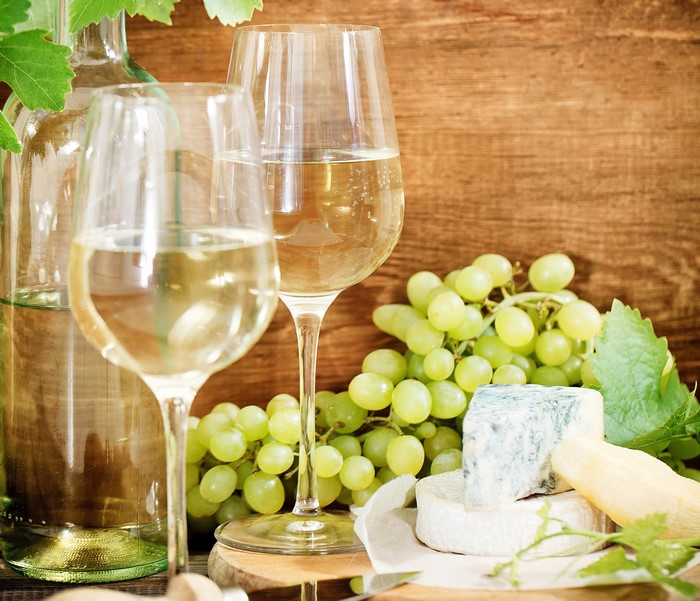 Wine, Grapes, and Cheese on a Wooden Table