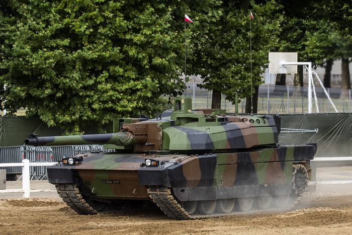 AMX Leclerc tank in camouflage driving on sand