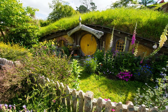 Hobbiton Park with a round yellow door and flowers