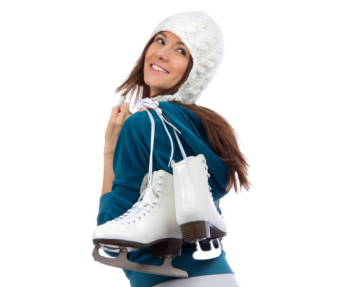 Woman with ice skates and winter hat