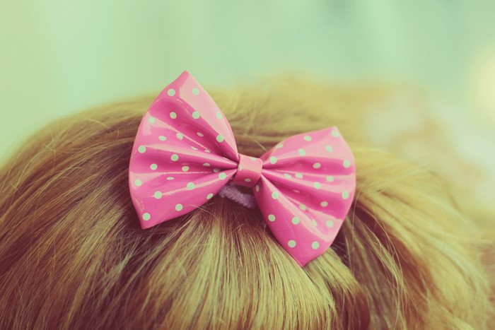 Pink polka dot bow on blonde hair