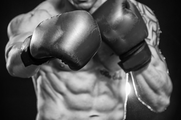 Man with boxing gloves and muscular torso