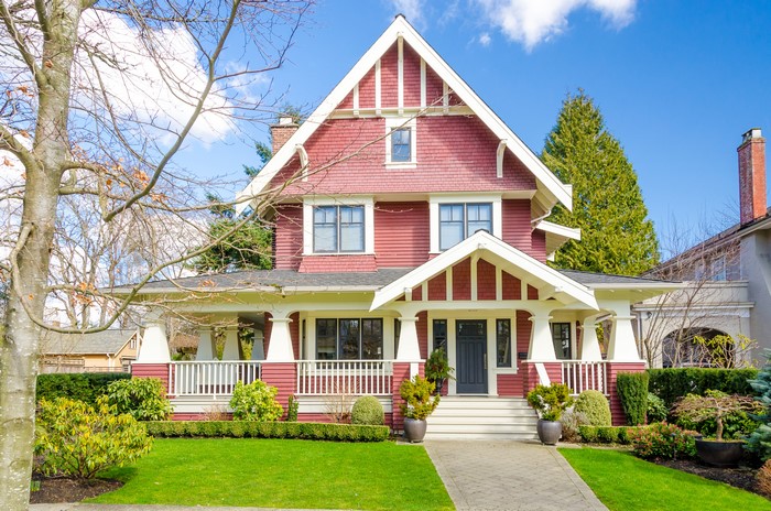 Red Craftsman House with Lawn and Shrubs