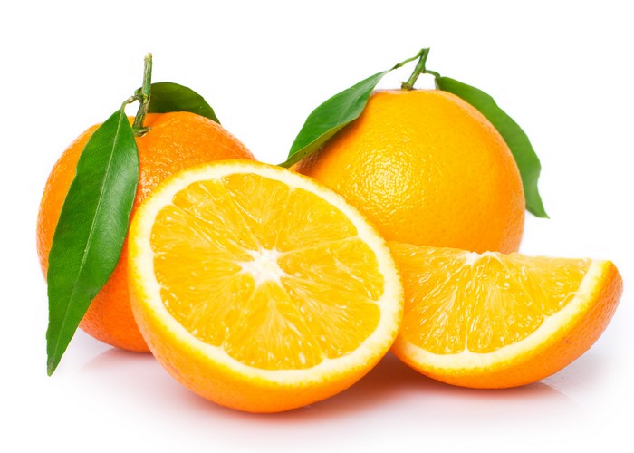 Oranges with leaves, one cut in half