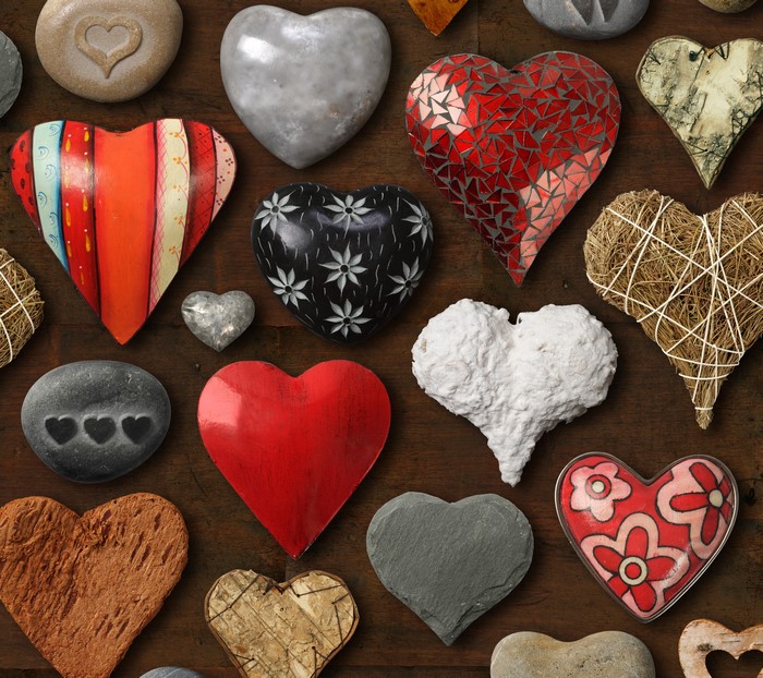 Many heart shapes on wooden background
