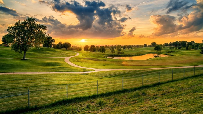 Golf course with pond and trees at sunset in Lees Summit, Missouri