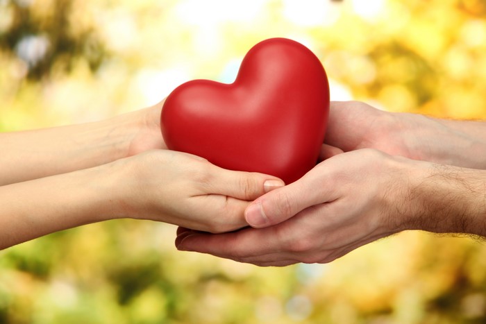 Hands holding a red heart