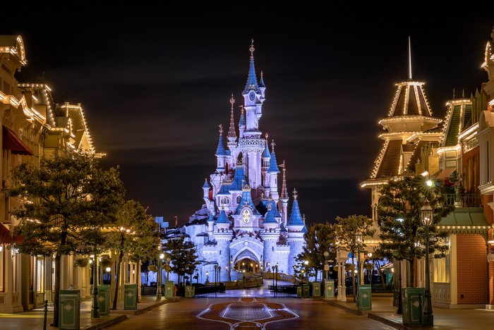 Disneyland castle at night with street lights