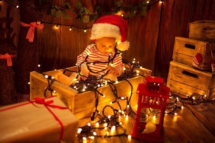 Baby in Santa hat with Christmas lights