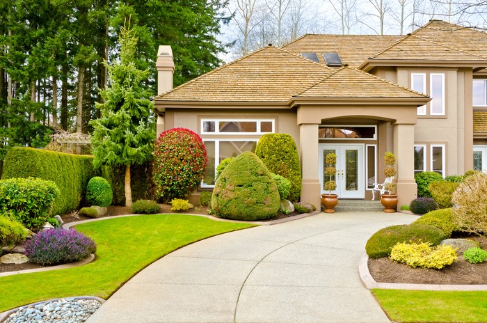 Luxury house with manicured lawn and trees