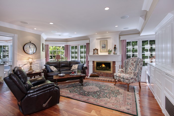 Living room with fireplace, sofa, and armchair