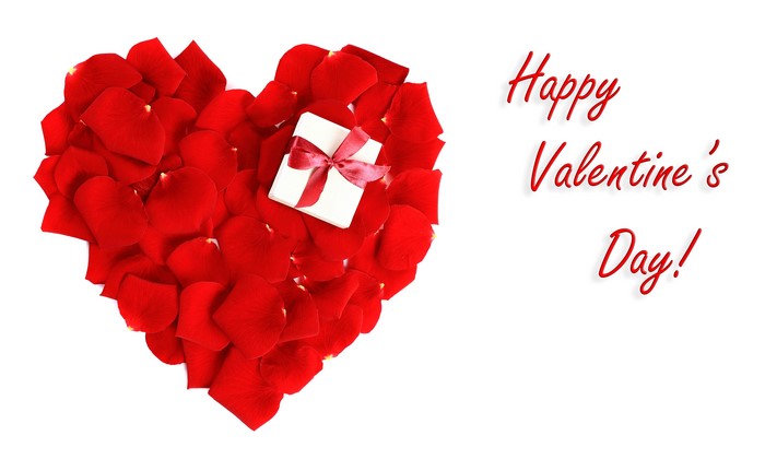 Valentine's Day heart made of red rose petals with a gift box