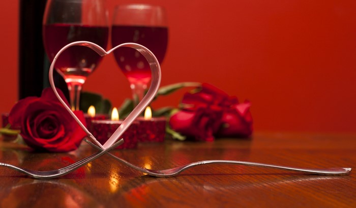 Valentine's Day romantic dinner setting with wine and roses