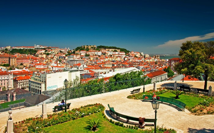 Lisbon cityscape with park benches and trees