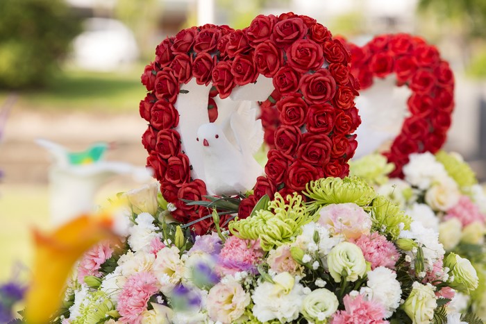 Heart-shaped floral arrangement with doves