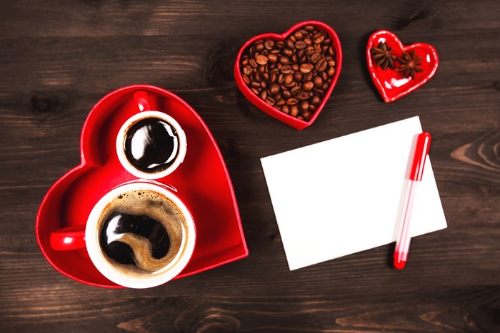 Valentine's Day coffee with heart-shaped tray and beans