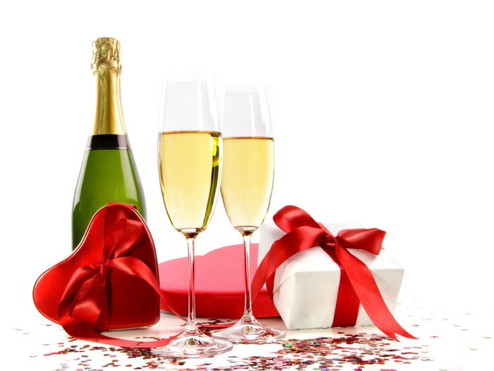 Champagne bottle and glasses with gifts