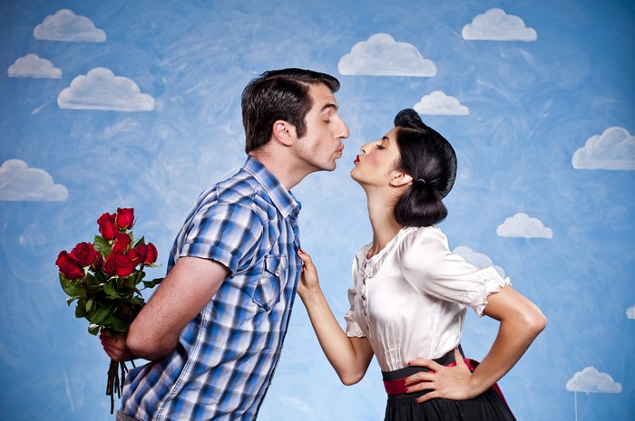 Couple kissing with roses on Valentine's Day
