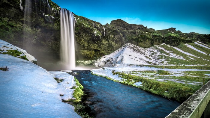 Seljalandsfoss Waterfall in Iceland with Snow and Moss