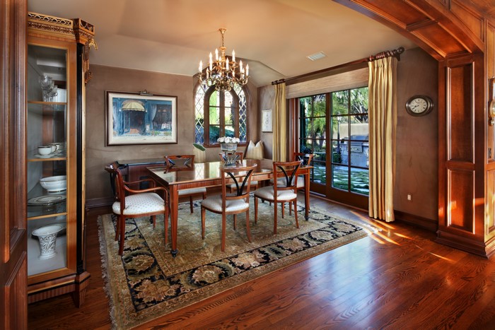 Dining room with table, chairs, chandelier, and carpet