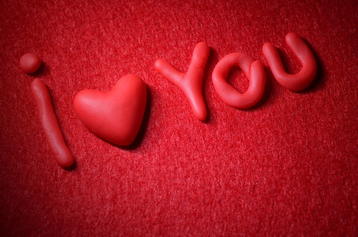 I Love You made of red clay on red background