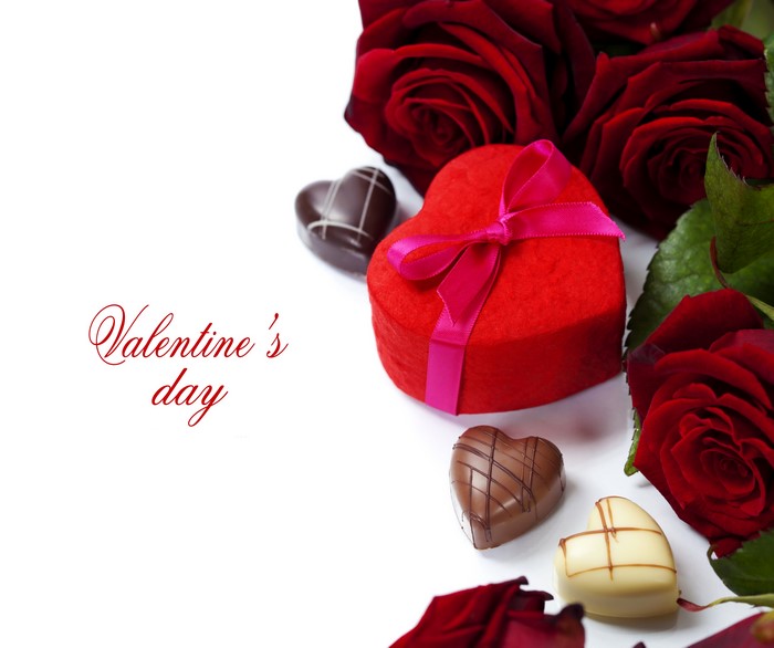 Valentine's Day red roses and heart-shaped gift with chocolates
