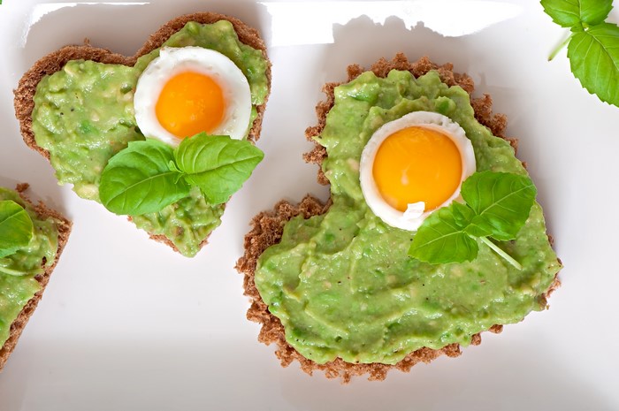 Heart-shaped avocado toast with fried egg