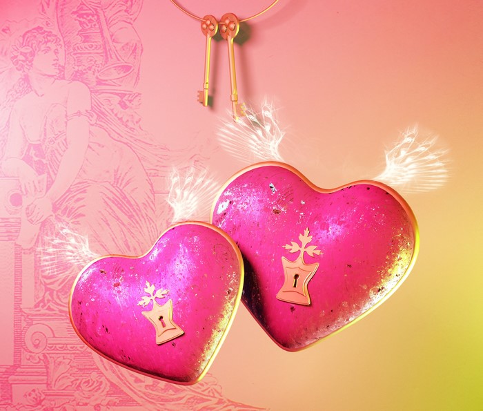 Two pink hearts with keys and wings