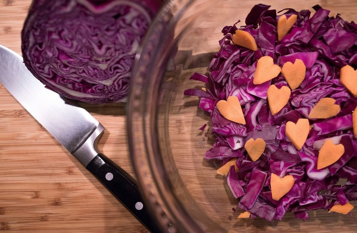 Red cabbage and knife on a cutting board