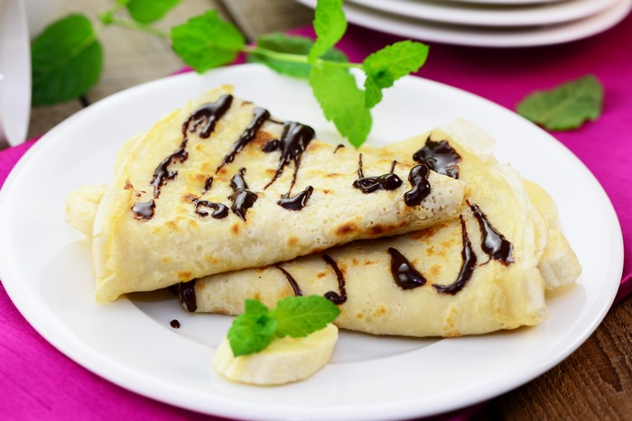 Pancakes with chocolate and banana on a plate