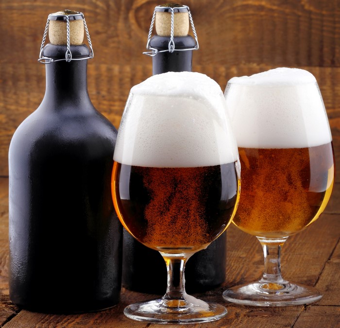 Two glasses of beer and two bottles